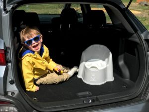 kid with potty in back of car - must-have products for active toddlers