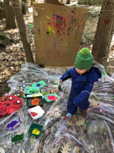 outdoor sensory play ideas - playing with paint