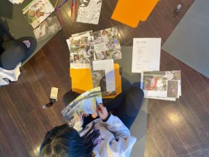 stress-busting tools for teens include making art out of old magazines - girls on floor with magazines