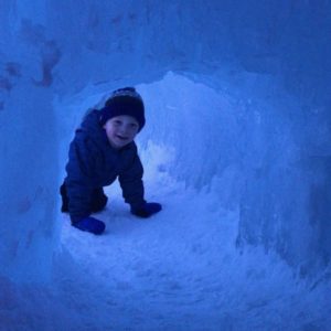 boy in an ice tunnel - family friendly events on the Seacoast in the winter