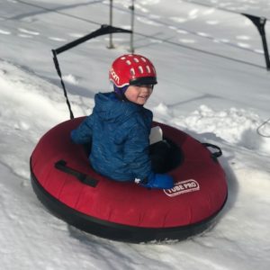 winter activities on the Seacoast - kid in a snow tube