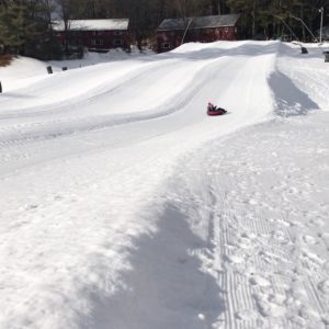 Seacoast winter fun for kids - child snowtubing an hour away from the Seacoast