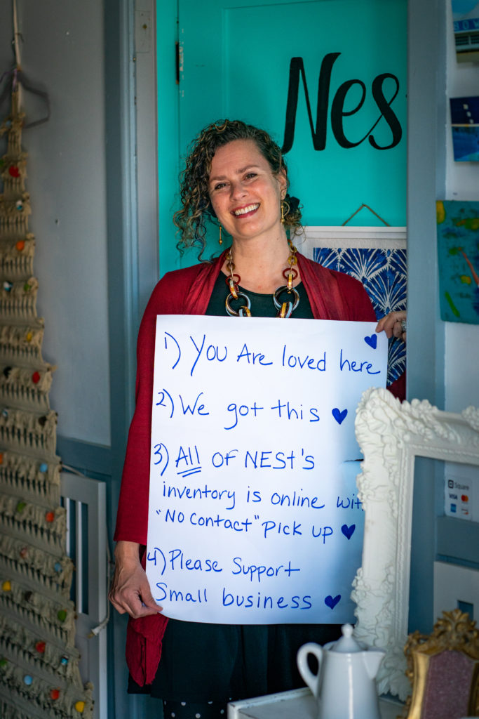 Maine Wedding Photographers - picture of Nest business owner holding sign