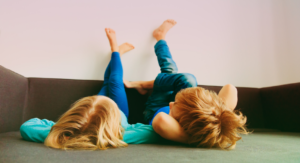 two young kids lying down with feet on the wall -- how to talk to young kids about sexism