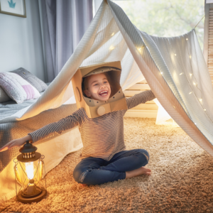 child in living room tent