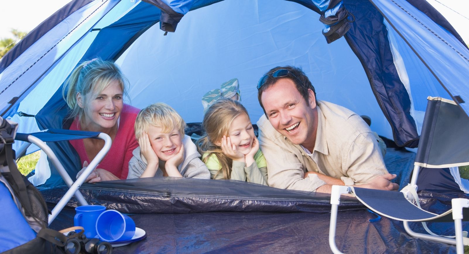 Family in blue tent