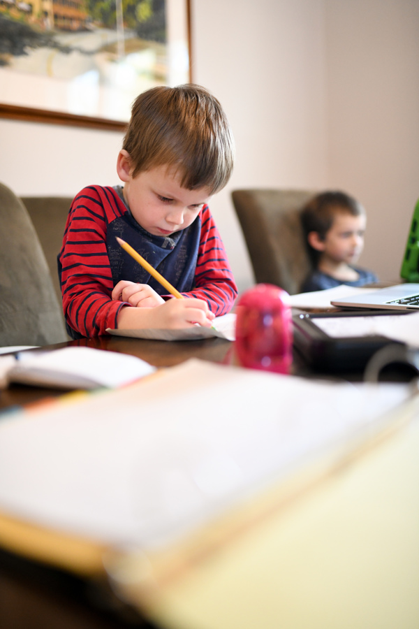boy with pencil working at table -- local resources for homeschooling in New Hampshire