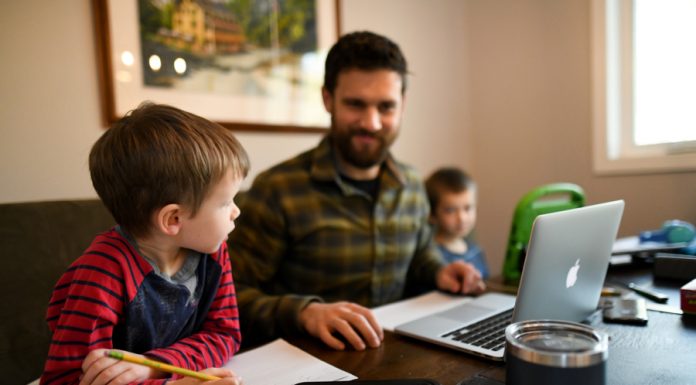 father at table with computer and two young sons - local resources for homeschooling in New Hampshire
