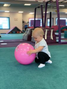 Baby playing with a pink ball - Safe Social Interaction on the Seacoast