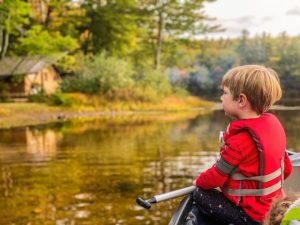 small child in canoe with life vest - where to get outside with kids on the Seacoast