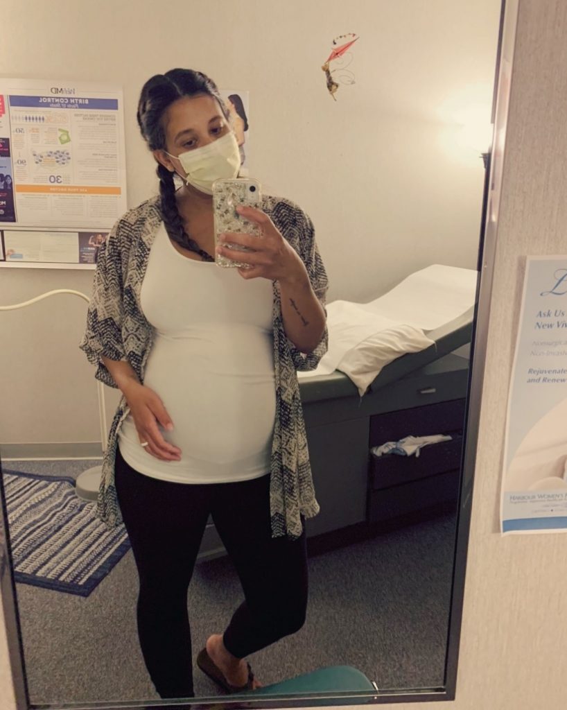 pregnant mother with a surgical mask