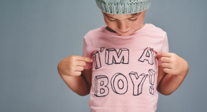boy in pink shirt that says im a boy