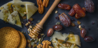Spread of food, crackers, cheese, sesame, nuts, honey, figs. Common food allergy myths. Image from Dana Tentis/Pexels