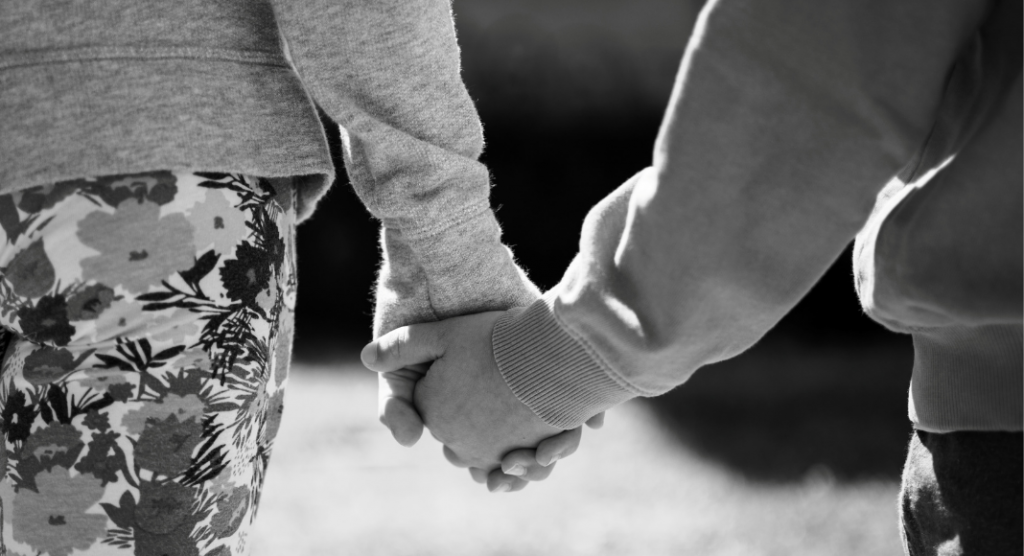black and white photo of two people holding hands, just hands are visible - mother's day lessons