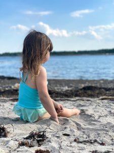 My daughter enjoys the sandy beach at Fort Stark