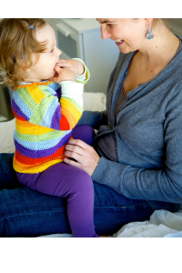 Mother on the right in blue top sits with toddler in her lap (on right) in rainbow top and purple leggings. Both are smiling after practicing breathing exercises for kids. 