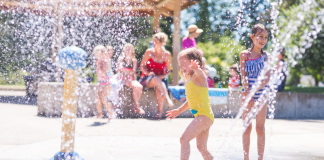 children run thorugh water features on Splash Pad