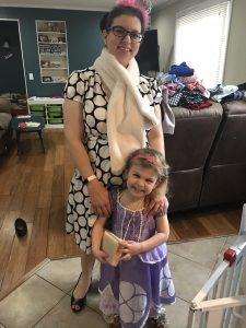 A mother and daughter playing dress-up