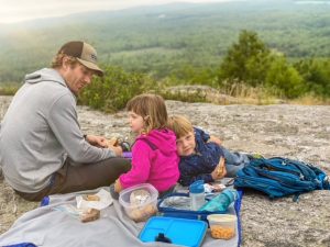 father and kids on mountain
